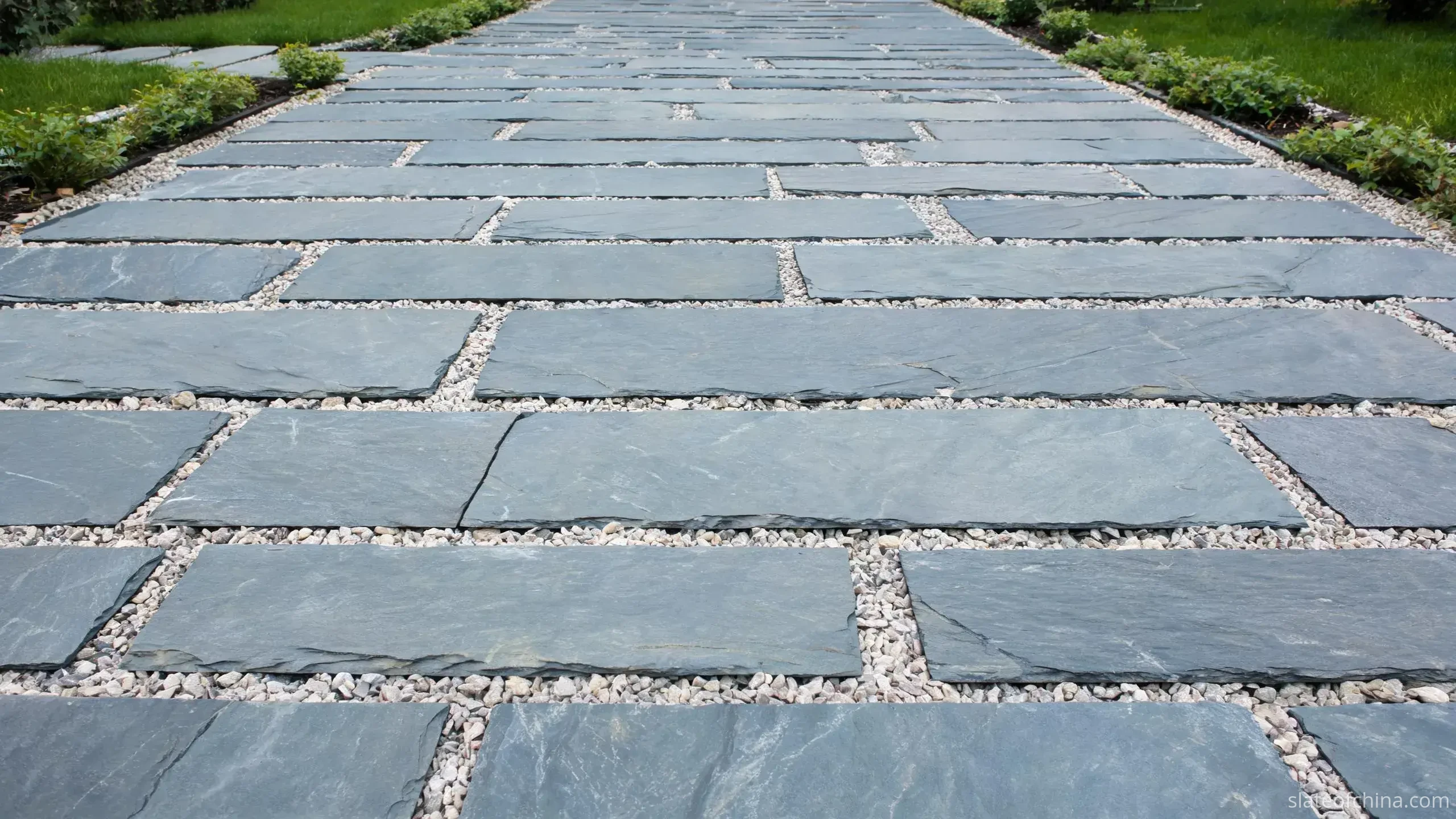 Jiujiang Slate Paving & Flooring 1 Blue-grey slate paving laid as large-format rectangles in a quiet garden patio, wide joints, planting and lawn at the edges
