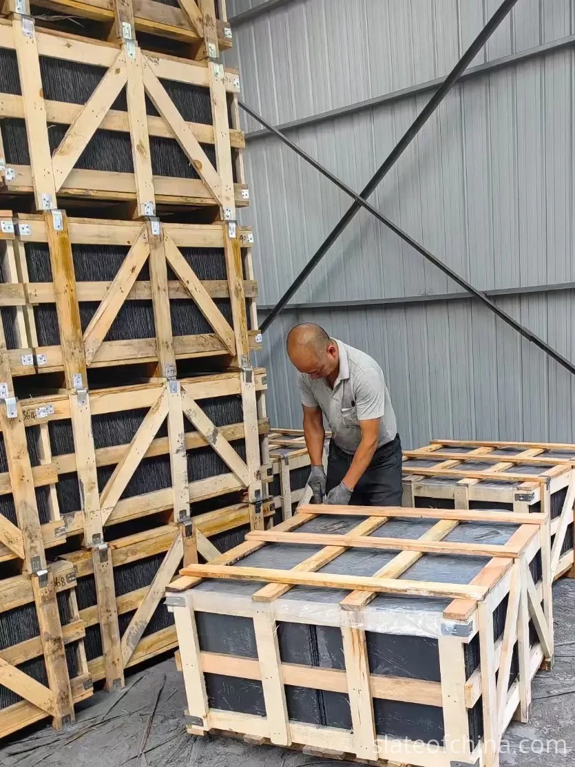 Jiujiang Slate Supply Chain 3 Wooden export crates packed with slate standing in a row in a factory yard, steel strapped with corner protection