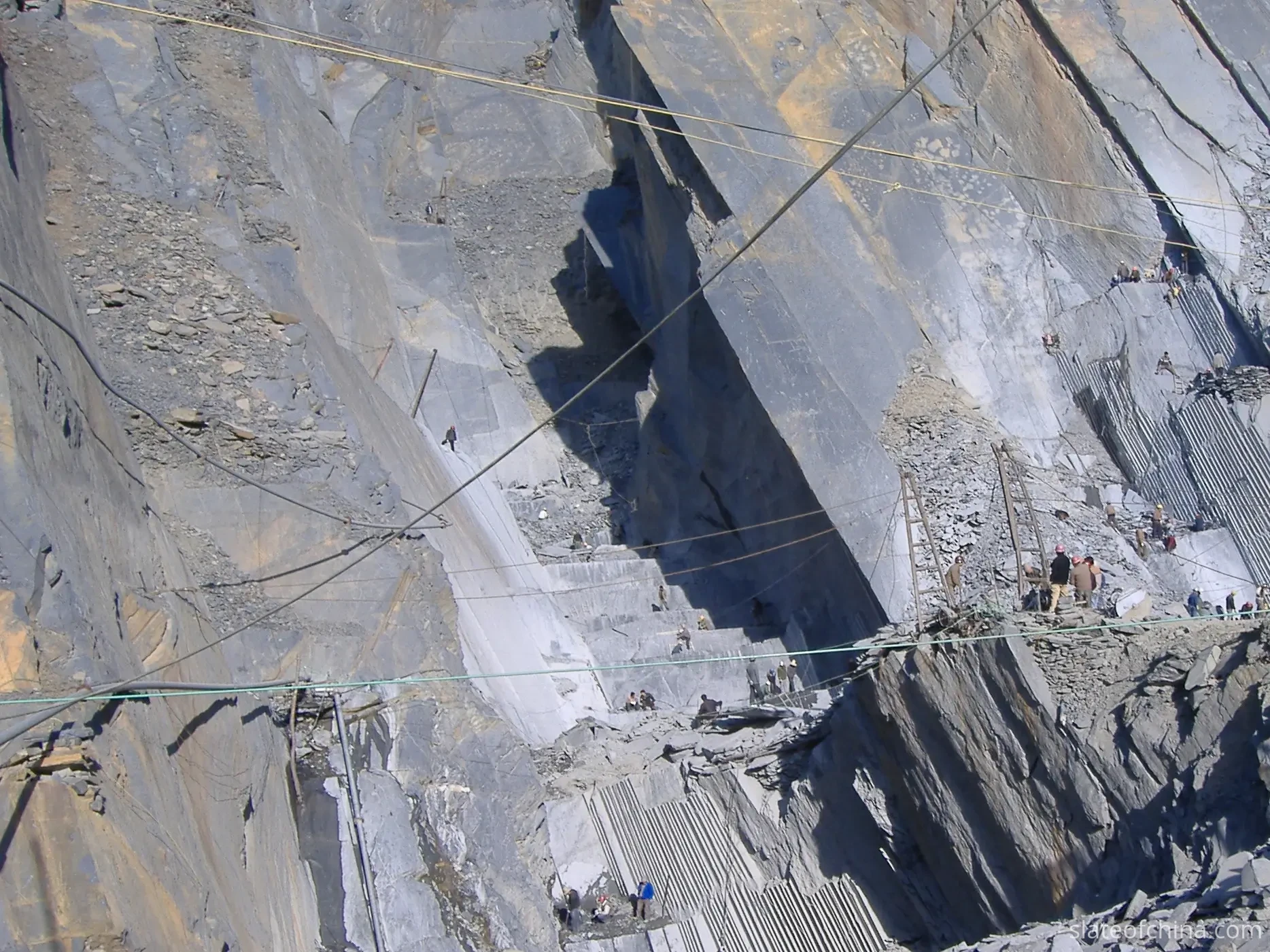 Jiujiang Slate Supply Chain 1 Close view of a natural slate quarry face near Jiujiang showing level bedding courses in cool blue-grey stone
