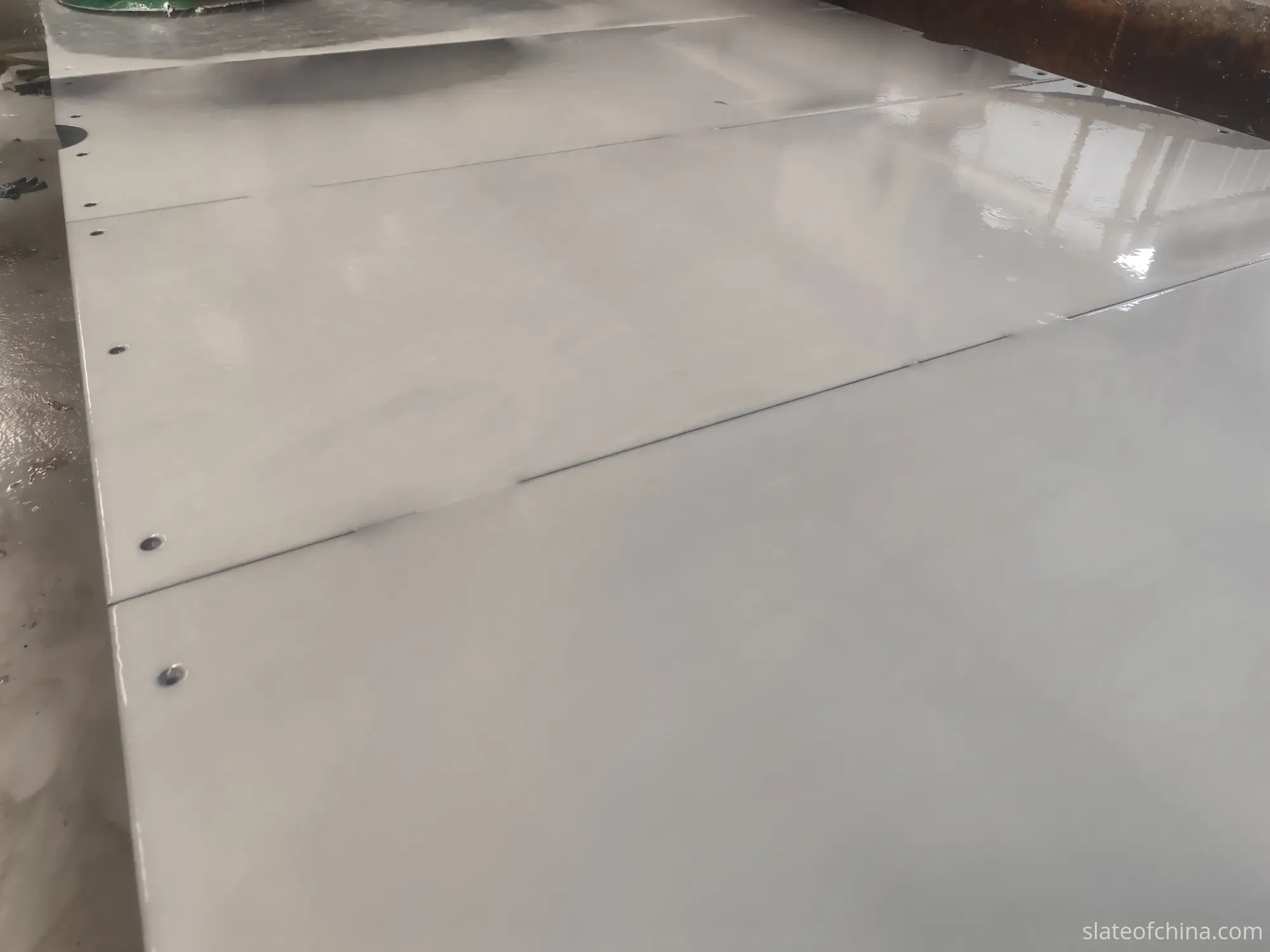Multi-piece slate set aligned for matched grinding and inspection Multiple slate panels aligned together showing joint lines between pieces