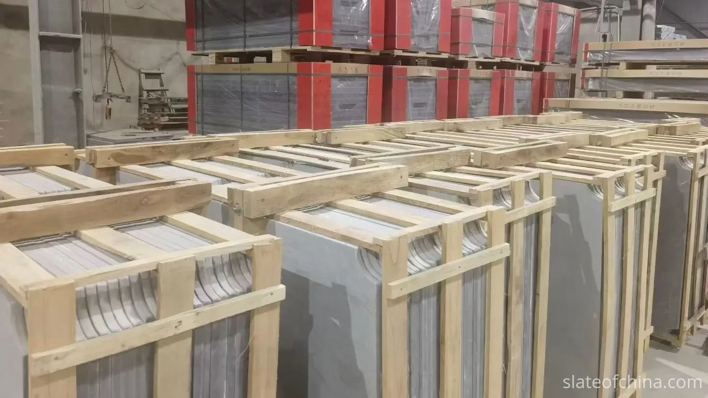 Export Wooden Crate Packing 2 Billiard slate panels standing vertically in open A-frame support frames mounted on wooden pallet bases in a factory warehouse, with foam separators between each panel