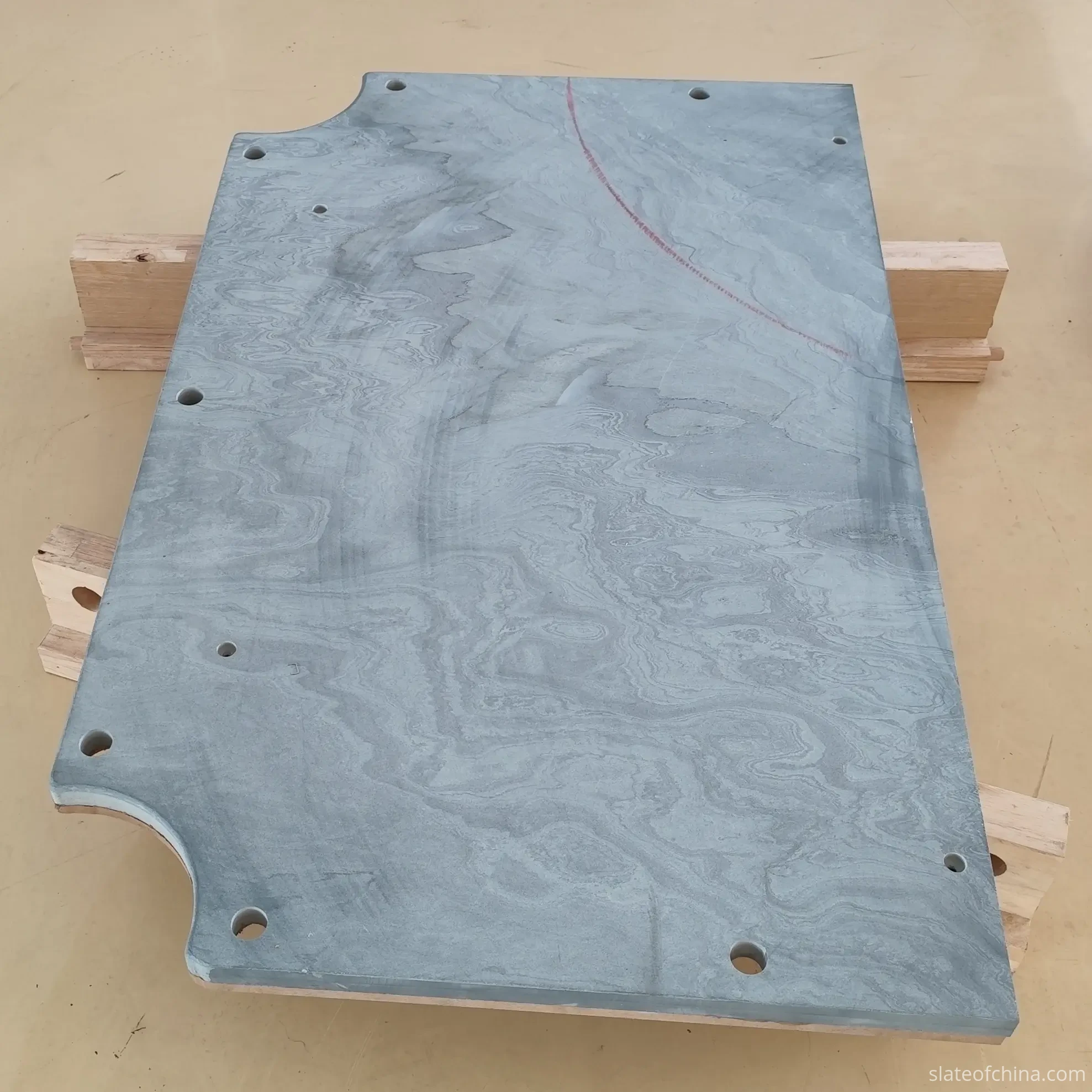 Replacement Slate for Existing Billiard Tables 2 Single billiard slate panel raised on timber blocks in a workshop, its full outline visible including two corner pocket notches and perimeter mounting holes