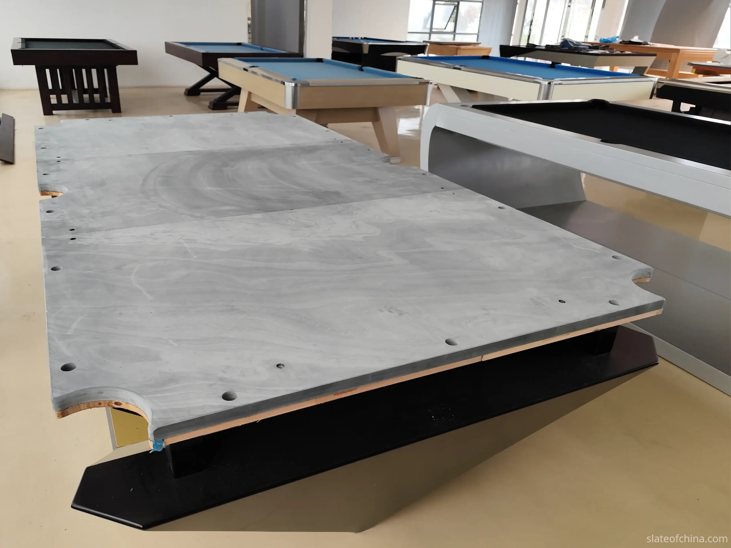 Replacement Slate for Existing Billiard Tables 4 Bare billiard slate bed on its table base with rounded pocket cutouts along the edges, before rails and cloth