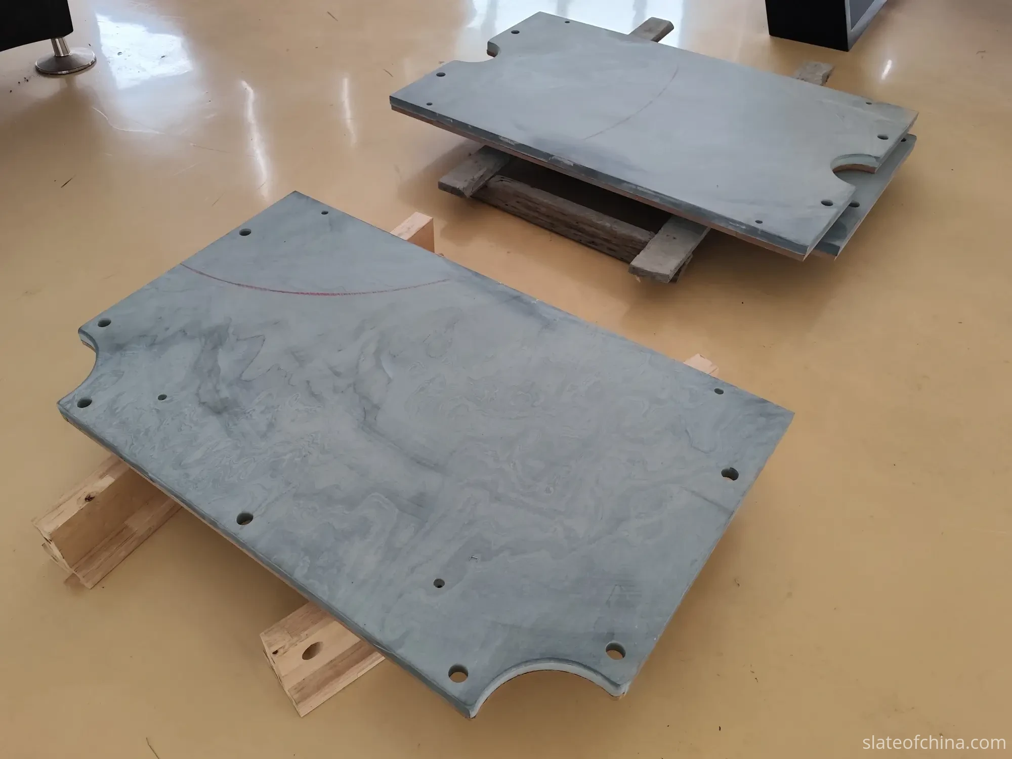 Slate Panel on Support Blocks for Inspection Billiard slate panel resting on wooden support blocks for flatness inspection