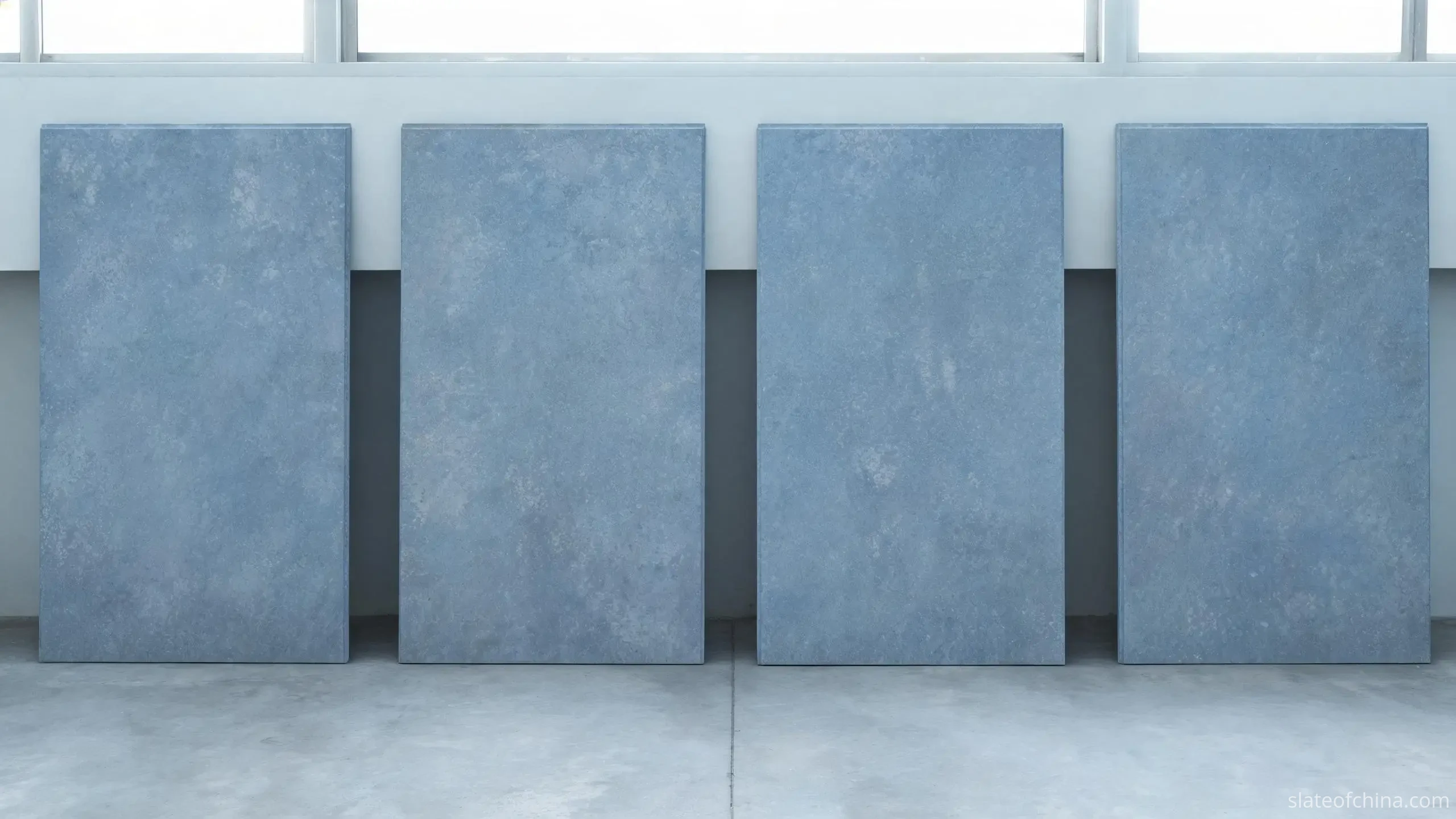 Slate Quarries and Processing in Jiujiang 2 Finished billiard table slate panels standing upright in a row inside a machining workshop