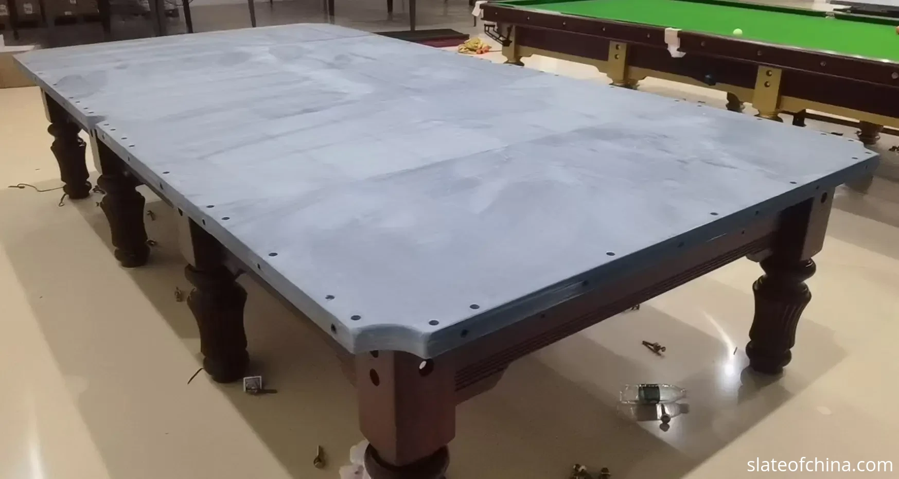 Pool Slate vs Snooker Slate 4 Partially assembled full-size snooker table with the multi-piece slate bed fitted to the frame before the cloth is installed