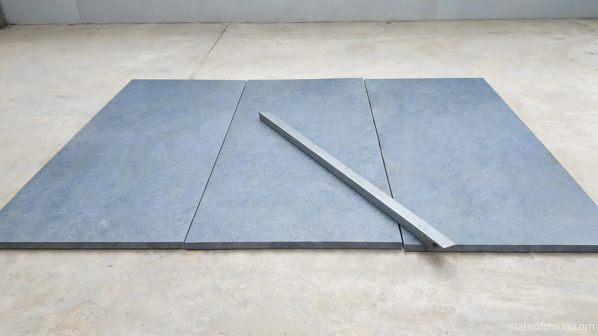 Slate Joint Alignment 1 A plain steel straightedge laid across the joints of a three-piece billiard slate set to check that the panels sit in one plane