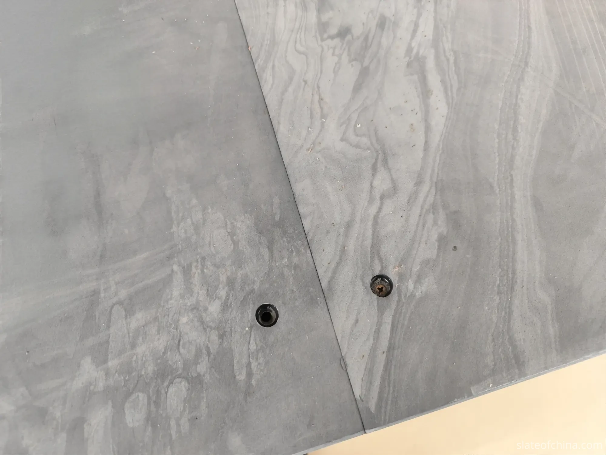 How Slate Flatness Affects Ball Roll 3 Two sections of billiard slate with a flush joint seam on the same plane, countersunk mounting holes with one fitted screw visible