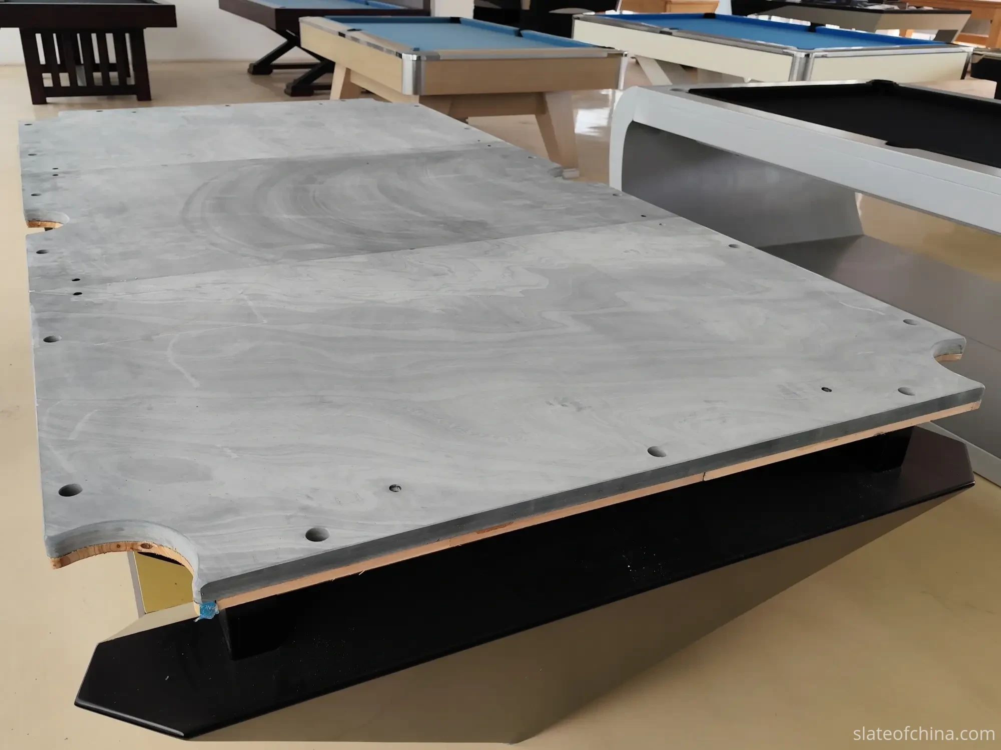 Slate Joint Alignment 4 A three-piece billiard slate bed assembled on a table frame for dry-assembly verification, two straight joints across the bed